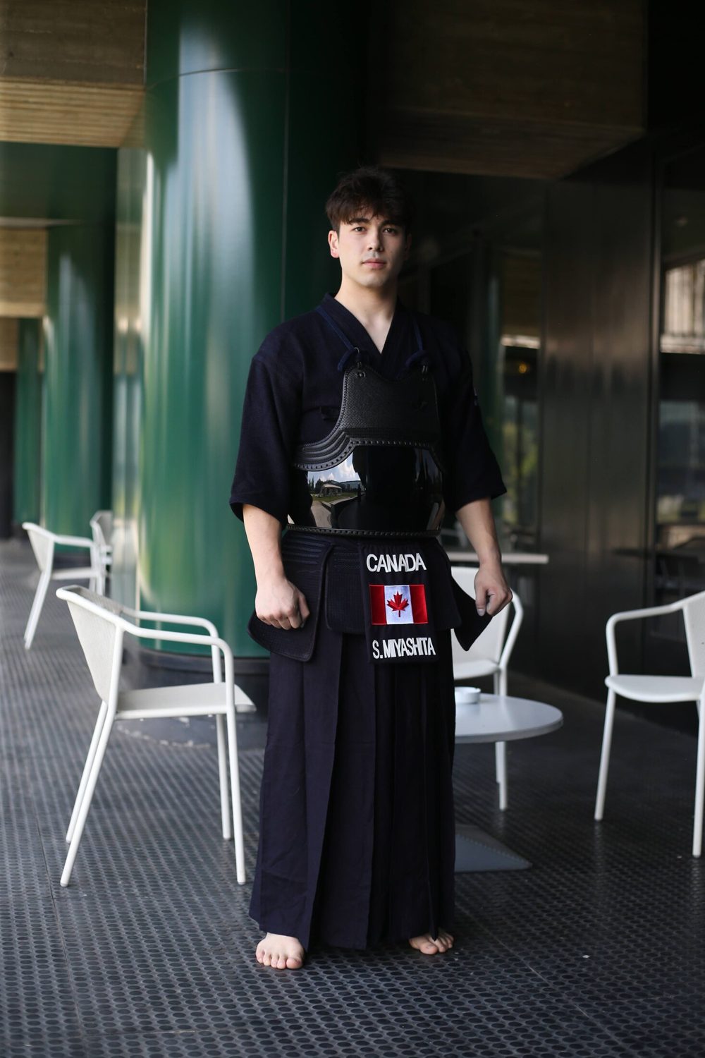 Shion Miyashita standing in kendo do and hakama, the Team Canada name plate reading CANADA and S. MIYASHITA at his waist